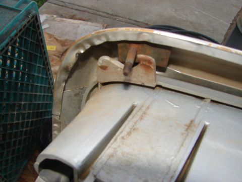 1973 Ford Ranchero - Close-up of a rusted mounting bracket on a vehicle component, next to a green crate.