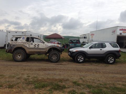 1999 Isuzu Vehicross - A stock Isuzu Vehicross is parked next to a modified version with off-road tires and number 33 displayed.