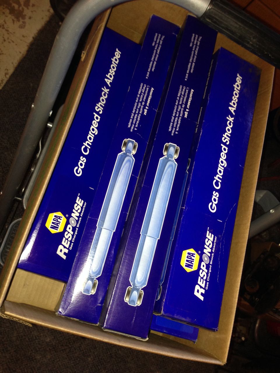 Four NAPA Response Gas Charged Shock Absorbers in blue boxes