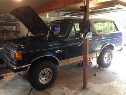 1990 Ford Bronco - This Ford Bronco is in a garage with its hood open and is being supported by a jack.