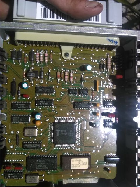 1992 Ford Bronco - Close-up of an engine control unit's circuit board, showing integrated circuits and electronic components.