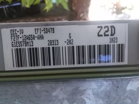 1992 Ford Bronco - Label on an engine control unit with part numbers and a barcode.
