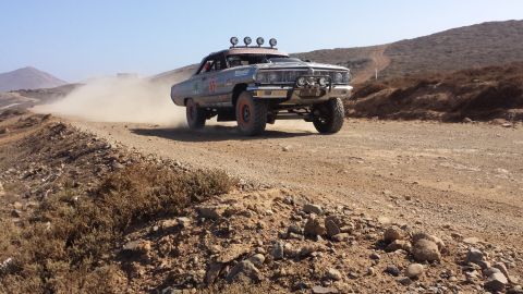 1996 Ford Bronco - This heavily modified sedan is racing on a dusty, off-road course.