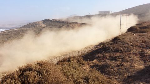 1996 Ford Bronco - An off-road vehicle creates a large dust cloud while traveling on a dirt path.