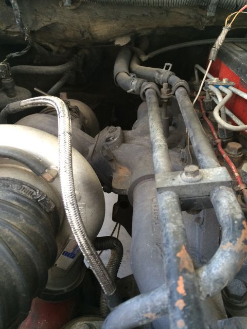 1997 Dodge 3500 - Close-up view of engine components, including a turbocharger and various hoses and pipes.