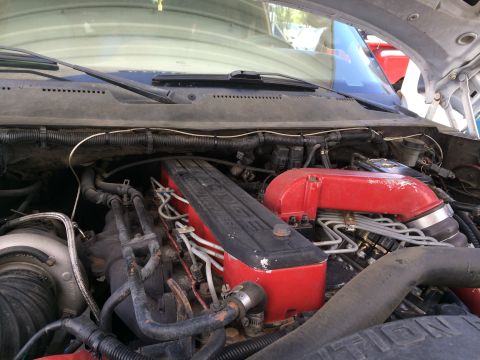 1997 Dodge 3500 - Close-up view of the engine bay in a 1997 Dodge 3500, highlighting the red intake manifold and black valve cover with visible 'DODGE' lette…