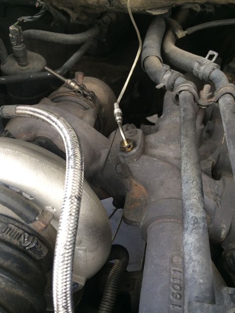 1997 Dodge 3500 - Engine bay view showing turbocharger and associated plumbing, with visible part numbers.