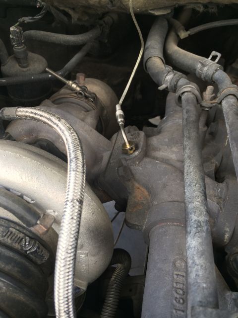 1997 Dodge 3500 - Engine bay view showing a turbocharger assembly with various hoses and wiring.