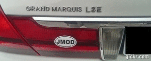 2000 Mercury Grand Marquis - The rear of a silver car is shown, a JMOD sticker on the taillight and 'GRAND MARQUIS LSE' badging.