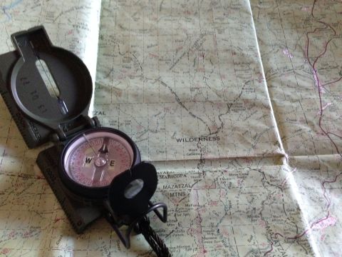 1996 Ford Bronco - A compass rests on a detailed map, indicating a path through wilderness areas.