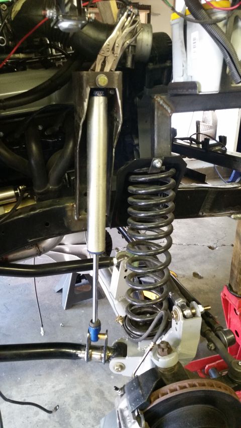 1968 Ford Bronco - This photo shows the front axle suspension system of a vehicle, with a shock absorber and coil spring.