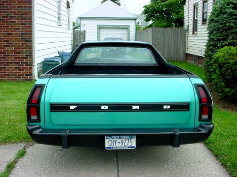 1973 Ford Ranchero - The rear of a teal Ford Ranchero pickup truck is shown parked in a driveway.