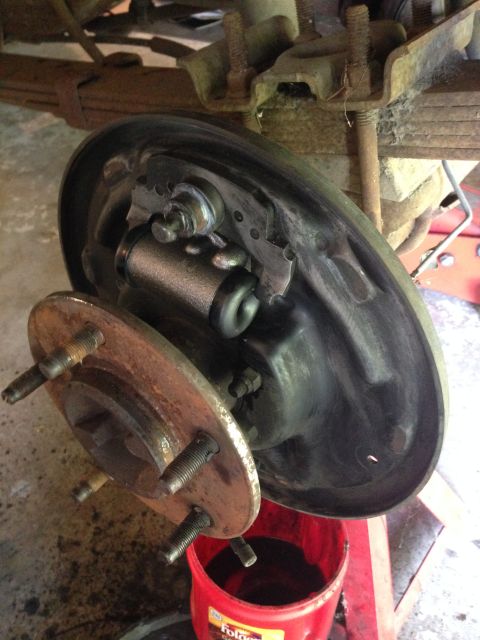 1990 Ford Bronco - Close-up of a vehicle's brake drum and wheel hub assembly, showing internal brake components.