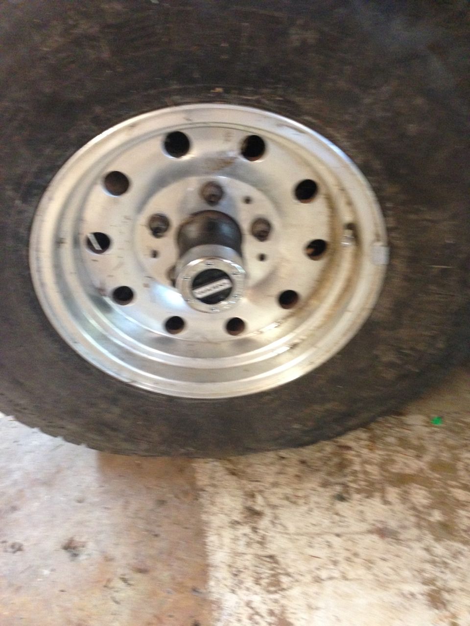 Close-up of a wheel with a chrome hubcap and tire