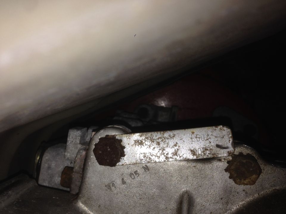Close-up of a metal part with stamped numbers 'T1 4 05 N' and 'E602'