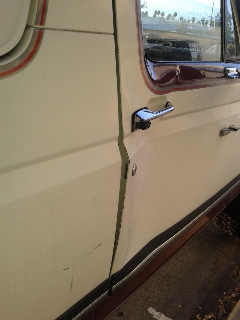 1990 Ford Bronco - Detail shot of a vehicle's door seam and handle, showing the body lines and trim.
