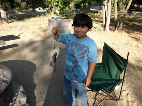 1988 Ford Bronco - A young boy proudly displays a fish he caught, likely during a camping trip.