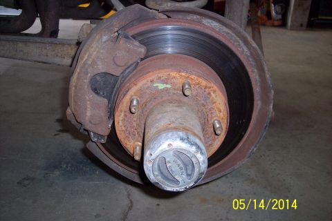 1978 Ford Bronco - Close-up view of a front wheel hub assembly, a Warn locking mechanism and brake rotor, likely from an older truck or SUV.