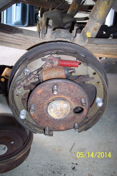 1978 Ford Bronco - This photo shows a close-up of a vehicle's rear brake drum assembly, a new red spring.