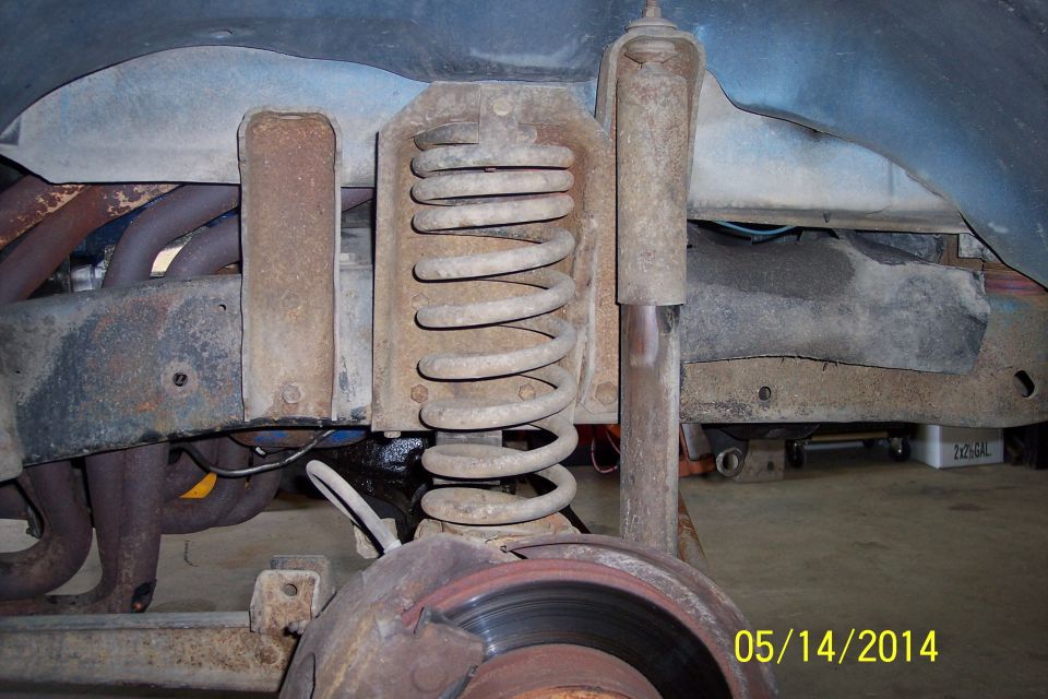 Front suspension coil spring and shock absorber assembly