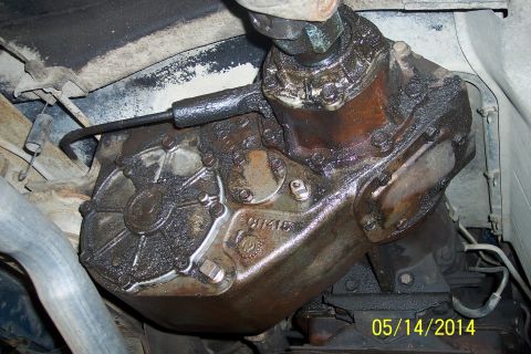 1978 Ford Bronco - The transfer case is covered in oil and grime, obscuring any specific identifying marks.