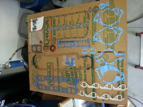 1994 Ford Bronco - A collection of engine gaskets and seals are spread out on a large cardboard box for display.