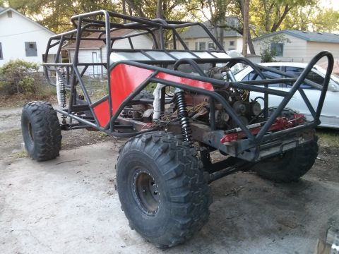 1986 Ford Bronco - This custom-built buggy features a prominent roll cage and oversized tires, suggesting it's designed for off-road use.