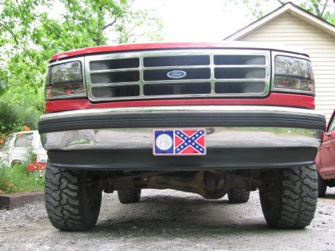 1992 Ford Bronco - Front view of a red 1992 Ford Bronco, its distinctive grille and chrome bumper.