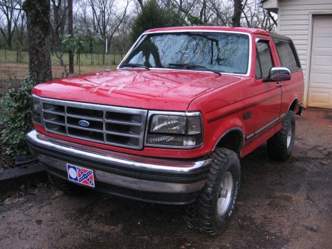 1992 Ford Bronco - Red 1992 Ford Bronco with aftermarket wheels and tires.