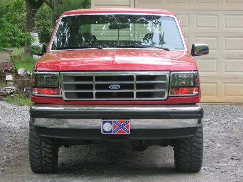 1992 Ford Bronco - Front view of a red 1992 Ford Bronco, its distinctive grille and headlights.