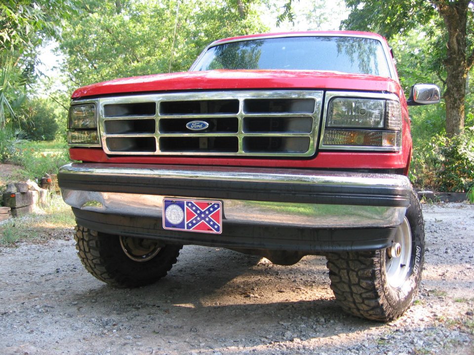 Red 1992 Ford Bronco front view with chrome grille and bumper