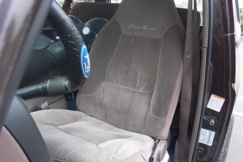 1992 Ford Bronco - The interior of the vehicle shows an Eddie Bauer branded seat and a Ford logo on the steering wheel.