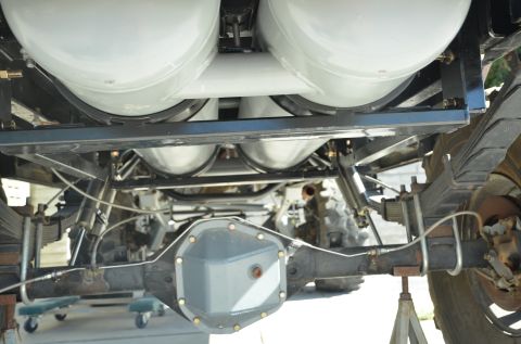 1979 Ford Bronco - Undercarriage view shows dual propane tanks installed above the rear axle assembly.