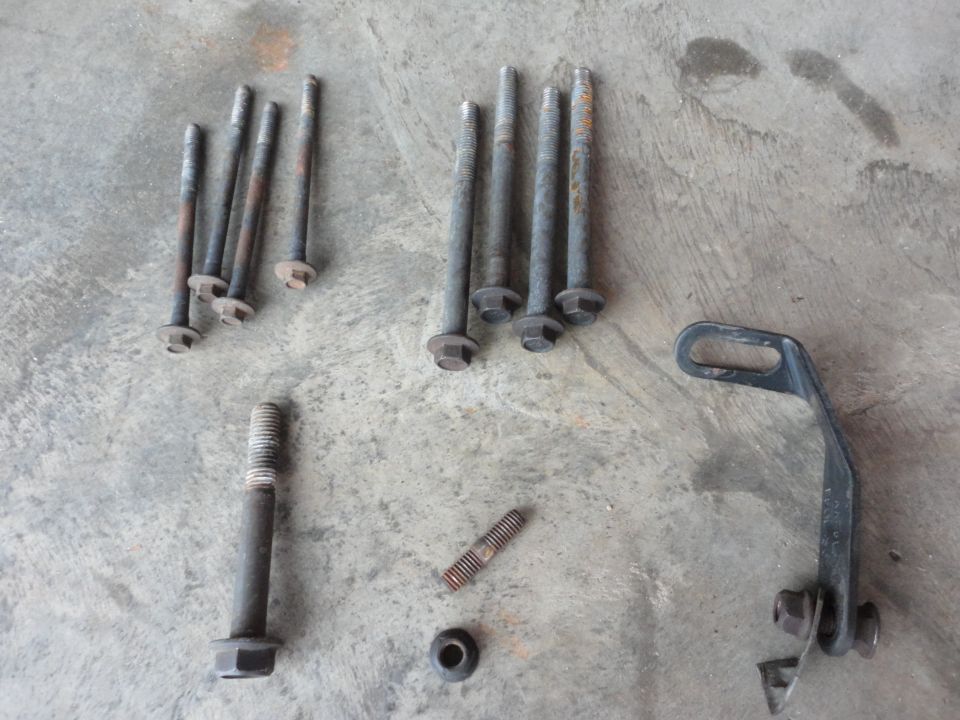 Hardware (clockwise from bottom center):

Water pump mounting stud/nut
Tensioner bolt
A/C compressor bolts
Bracket to engine block mounting bolts
Bracket from back of pump to exhaust manifold bolt (bolt broken in this pic)