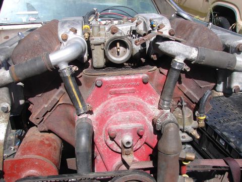 1973 Ford Ranchero - Close-up of a corroded engine with visible hoses and carburetor components.