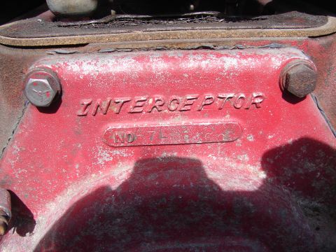 1973 Ford Ranchero - Close-up of a red engine component with the name "INTERCEPTOR" and a serial number visible.