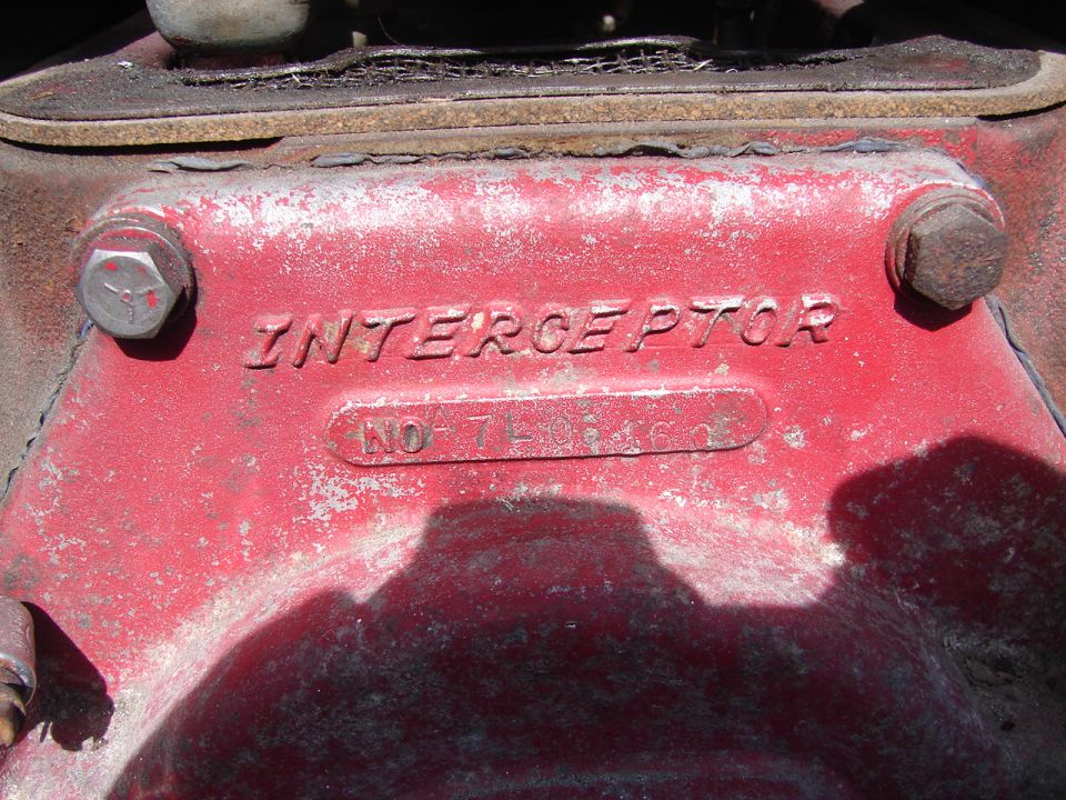 Red engine part stamped "INTERCEPTOR" and a serial number