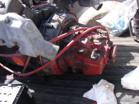 1973 Ford Ranchero - A red transmission with silver housing and red hoses is seen in a truck bed.