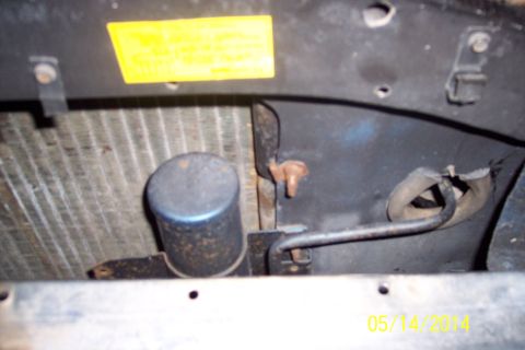 1978 Ford Bronco - Close-up view of engine bay components, showing a radiator and a blue-capped reservoir.