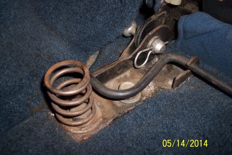 1978 Ford Bronco - The photo shows a close-up of a seat adjustment mechanism with a spring and lever, set against blue carpet.