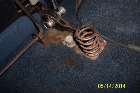 1978 Ford Bronco - Interior view of a vehicle's floor mechanism, showing a rusty spring and lever assembly.