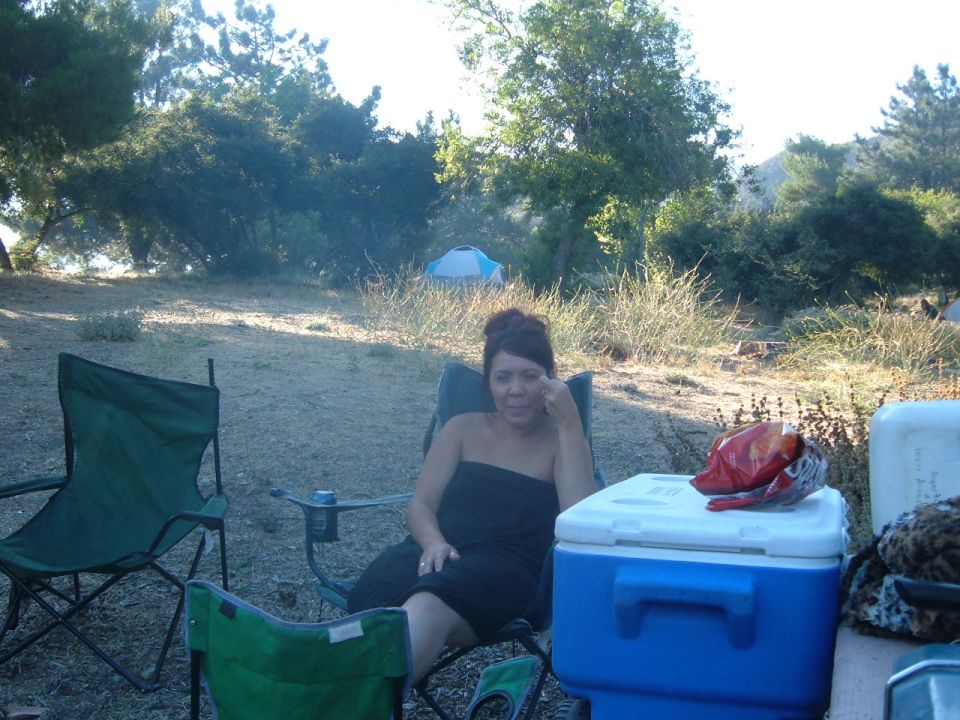 Woman in camping chair by cooler