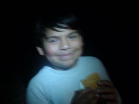 1988 Ford Bronco - A young boy smiles while eating a s'more in the dark, with a Supermotors.net watermark visible.