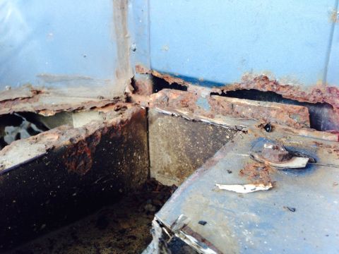1979 Ford Bronco - Extensive rust damage is visible on the vehicle's structural metal components.