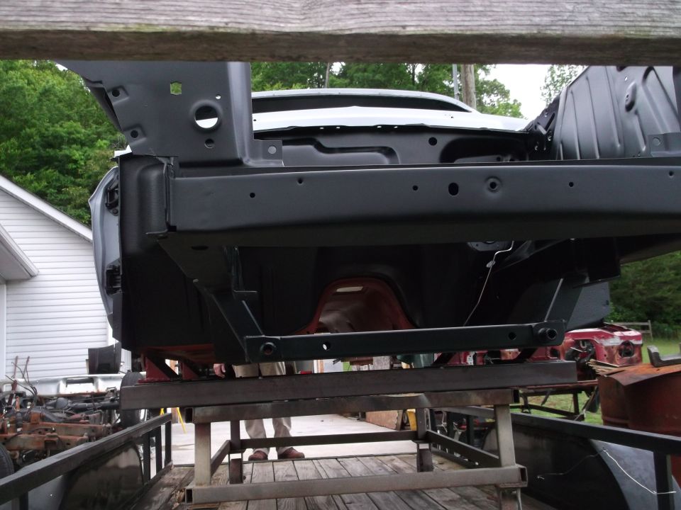 Car frame being worked on, possibly a restoration project