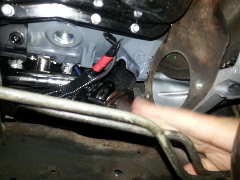 1994 Ford Bronco - Underside view of engine components, showing wiring harness and mounting brackets.