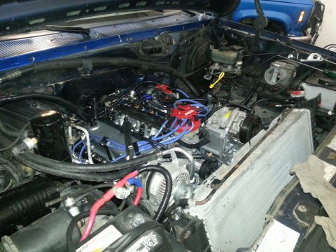 1994 Ford Bronco - The engine bay shows a new MSD distributor and blue spark plug wires, with another vehicle partially visible in the background.