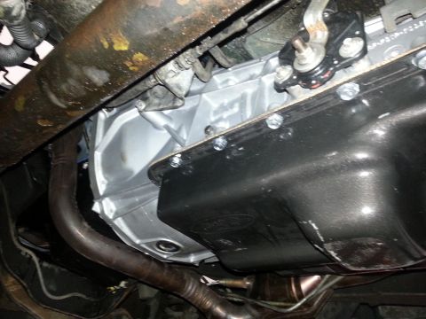 1994 Ford Bronco - Underside view shows the transmission pan and exhaust system components.