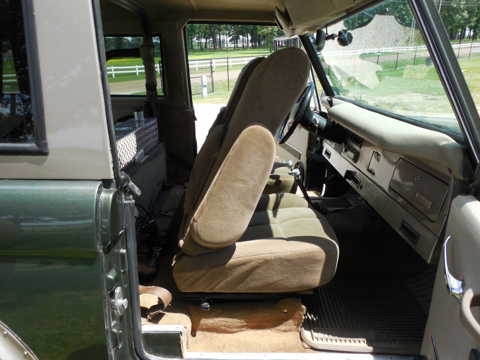 Just like the driver's, this chair slides fore-aft (black lever in front), and reclines (chrome lever on the other side).  But this one also dumps forward (black lever at bottom rear) to reveal a storage box below.