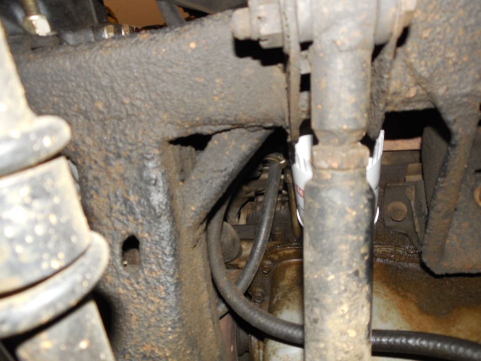 Looking up from the LHF tire at the track bar, oil filter, & oil pan